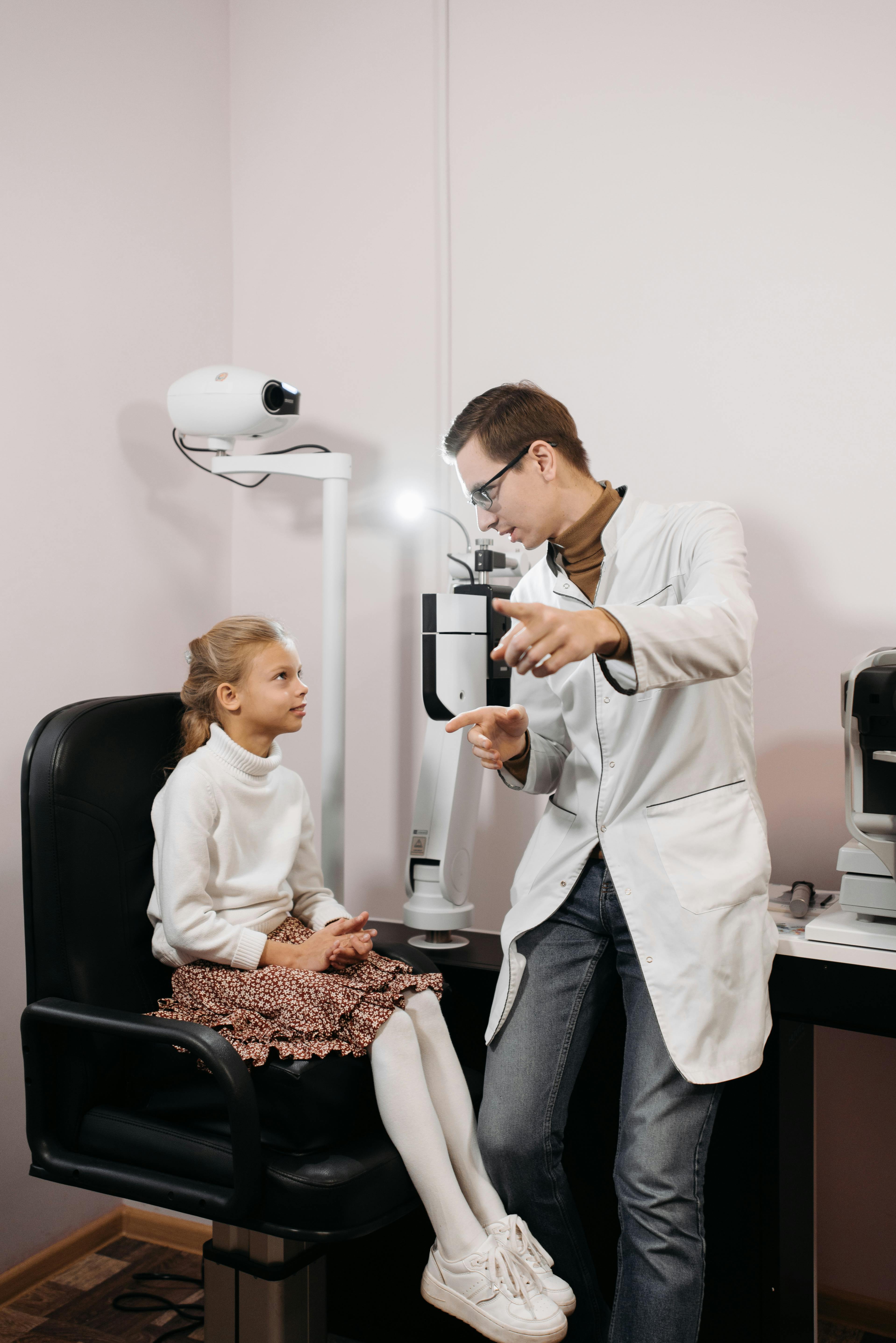 Eye care specialist consulting with a young patient
